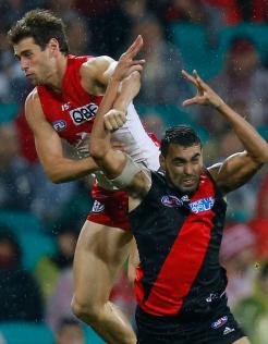 Courtenay Dempsey is crunched by Nick Smith during the Bombers' clash with Essendon - ${keywords}